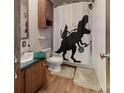 Fun bathroom with a dinosaur shower curtain, green counter, and neutral flooring at 3379 Appletree Ct, Vale, NC 28168