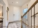 Inviting foyer with wooden stairs, a window, light-colored flooring and a white door at 4132 Skyboat Cir, Fort Mill, SC 29715
