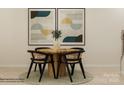 Cozy dining area with a round wooden table, stylish chairs, and modern artwork enhancing the space at 4539 Potters Wheel Dr, Fort Mill, SC 29715