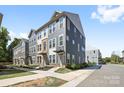 An eye-level exterior shot showcasing the townhouse, its stylish facade, and well-kept landscaping at 5005 Sovereignty Ct, Charlotte, NC 28205
