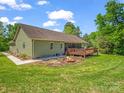 A spacious backyard with a wooden deck and fire pit, great for entertaining outdoors at 575 Hill Rd, Lincolnton, NC 28092