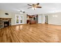 Open-concept living area with hardwood floors, stone fireplace, and access to the backyard at 575 Hill Rd, Lincolnton, NC 28092