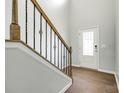 Foyer featuring a staircase with wrought iron spindles and a hardwood floor, creating a grand entrance to the home at 609 Kahana River Rd, Fort Mill, SC 29715