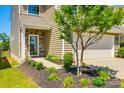 Well-manicured front yard with a tree and walkway leading to the front door, showcasing the home's inviting exterior at 609 Kahana River Rd, Fort Mill, SC 29715