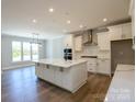 The spacious kitchen offers white cabinets, marble countertops, and stainless steel appliances at Tbd Boomer Ct # 10, Statesville, NC 28677
