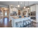 Bright kitchen with white cabinets, stainless steel appliances, and island with bar seating at Tbd Boomer Ct # 12, Statesville, NC 28677