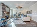 Spacious living room with a stone fireplace, modern decor, and plenty of natural light at Tbd Boomer Ct # 12, Statesville, NC 28677
