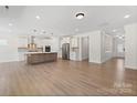Spacious open-concept living room featuring hardwood floors and natural light next to the kitchen at Tbd Boomer Ct # 13, Statesville, NC 28677