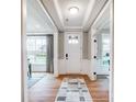 Bright foyer with hardwood floors, white wainscoting, and view to the outside at Tbd Boomer Ct # 14, Statesville, NC 28677