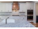 Bright kitchen with granite counters, white cabinets, stainless steel appliances, and a stylish tile backsplash at Tbd Boomer Ct # 8, Statesville, NC 28677