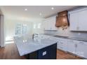 Modern kitchen featuring a large island with granite countertops, white cabinets, and stainless steel appliances at Tbd Boomer Ct # 8, Statesville, NC 28677