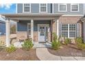 Inviting front porch with cozy seating area, perfect for enjoying the outdoors at this lovely home at 1043 Kalli Dr, Matthews, NC 28104