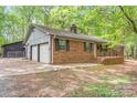 A well-maintained brick home with green shutters and a two-car garage, offering classic curb appeal at 111 Pine Grove Church Rd, Concord, NC 28025