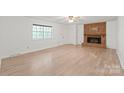 Bright living room with brick fireplace and light wood floors, offering a spacious and inviting atmosphere at 111 Pine Grove Church Rd, Concord, NC 28025