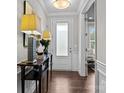 Bright entryway features hardwood floors, elegant console table, and access to a study at 11227 Whimbrel Ct, Charlotte, NC 28278