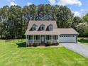 Charming home featuring a welcoming front porch and a well-maintained landscaped yard at 1228 Swift Rd, Oakboro, NC 28129