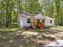 A quaint, single-story home featuring a inviting front porch with natural wood features and green lawn at 1241 Pitts Rd, Chester, SC 29706