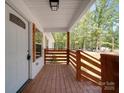 Inviting front porch with natural wood railing, door, and trim, perfect for relaxing outdoors at 1241 Pitts Rd, Chester, SC 29706