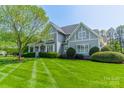 Beautiful home with a well-manicured lawn and classic architectural details at 125 Swayne Dr, Mooresville, NC 28117