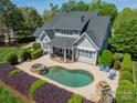 Aerial view of a home with a backyard oasis featuring a pool and patio area at 125 Swayne Dr, Mooresville, NC 28117