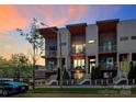 Beautiful modern townhome with multiple balconies and manicured landscaping under a colorful twilight sky at 1416 S Church St, Charlotte, NC 28203