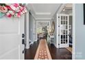 Elegant foyer featuring hardwood floors, decorative rug and an open view of the staircase and living spaces at 164 Riverstone Dr, Davidson, NC 28036