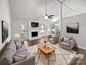 Bright living room with fireplace, ceiling fan, and open floor plan to the dining area at 1727 Running Brook Rd, Charlotte, NC 28214