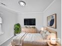 Serene main bedroom featuring a neutral color scheme, ample natural light, and a comfortable king-sized bed at 1727 Running Brook Rd, Charlotte, NC 28214