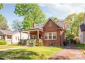 Charming brick home with a cozy front porch and well-maintained landscaping at 2221 Commonwealth Ave, Charlotte, NC 28205
