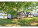 View of the backyard, landscaped lawn and lake with dock at 235 Commodore Loop, Mooresville, NC 28117