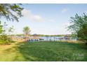 Expansive backyard lawn leading to a gazebo and dock on the lake at 235 Commodore Loop, Mooresville, NC 28117