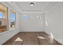 Bright living room with hardwood floors, tray ceiling, and multiple windows providing natural light at 277 Supernova Dr # 12, York, SC 29745