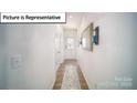 Bright entryway featuring hardwood floors and a decorative front door at 3023 Sassafras Trl, Gastonia, NC 28056