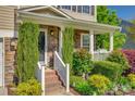 The beautiful front porch has stone accents, brick steps, and lush, mature landscaping at 3040 Sunshower Hts, York, SC 29745