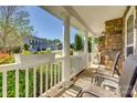Inviting front porch with chairs and charming flower boxes on the white railing at 3040 Sunshower Hts, York, SC 29745