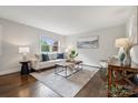 Comfortable living room featuring hardwood floors, natural light, stylish decor and a cozy seating arrangement at 3725 Dunwoody Dr, Charlotte, NC 28215
