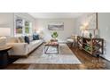 Bright living room boasts hardwood floors, a large window, comfortable seating and modern decor at 3725 Dunwoody Dr, Charlotte, NC 28215