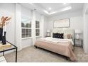 Inviting bedroom featuring soft colors, tray ceiling, plush bedding, and ample natural light at 538 Williamson St, Charlotte, NC 28208