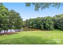 Expansive backyard with a lush green lawn and a beautiful lake view with a dock at 58 Ridgeport Rd, Clover, SC 29710