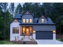 Inviting two-story home, showcasing great curb appeal with its well-lit entrance and complementary textures at 6265 Riviera Run Estates Dr, Hickory, NC 28601