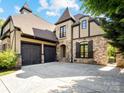 Stunning home featuring a three-car garage, unique architectural details, and impeccable design at 703 Sainte Rose Ln, Charlotte, NC 28226