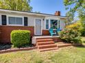 Inviting front porch with blue chairs and well-maintained brick steps at 7617 Pleasant Hill Church Rd, Marshville, NC 28103