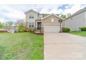 Charming two-story home with a well-manicured lawn, two car garage and a basketball hoop at 807 Oak Manor Se Dr, Concord, NC 28025