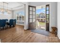 Spacious entryway with hardwood floors and view into the dining area, open front door at 811 Penny Royal Ave, Fort Mill, SC 29715