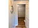 Hallway leading to the closet space with sleek hardwood floors and neutral walls giving a clean, modern look at 9404 Robert Burns Ct, Charlotte, NC 28213