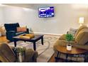 Inviting living room with comfortable seating, a wooden coffee table, and a large screen TV for entertainment at 9404 Robert Burns Ct, Charlotte, NC 28213