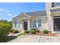 Charming one-story home featuring a welcoming front porch and beautifully landscaped front yard at 101 N Ferncliff Dr, Mount Holly, NC 28120