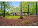Inviting single-story home nestled among trees with mature landscaping at 109 Canterbury Ln, Matthews, NC 28104