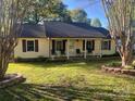 Charming ranch-style home featuring a covered porch and mature trees accenting the manicured front lawn at 109 Wilson Acres Dr, Kings Mountain, NC 28086