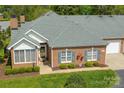Aerial view of a well maintained brick home with manicured lawn and attractive landscaping at 11346 Olde Turnbury Ct, Charlotte, NC 28277